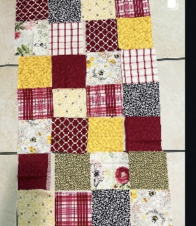 Patchwork fabric pieces arranged for a handmade project