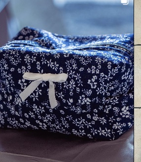 Handmade fabric makeup tote bag on a craft table