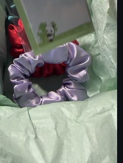 Satin scrunchies arranged on a soft surface